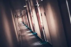 cruise-ship-staterooms – United Outcomes – United Outcomes Hallway of a cruise ship with closed doors hiding HR issues