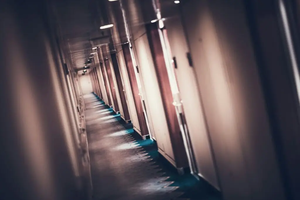 cruise-ship-staterooms – United Outcomes – United Outcomes Hallway of a cruise ship with closed doors hiding HR issues