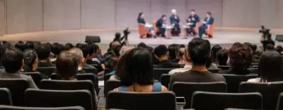 Martyns Law applies to conferences – United Outcomes – United Outcomes Rear view of the Audience is large enough for Martyn's law to apply in a conference hall or seminar meeting.