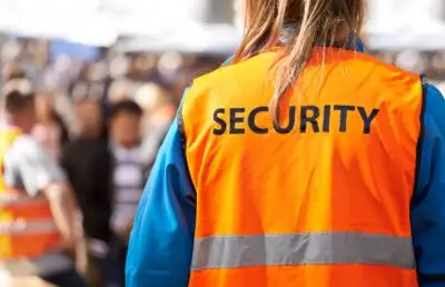 security guard with crowded background monitoring for Martyn's Law